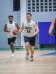 Matt and Brad playing an intense game of basketball indoors.