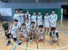 Blake and his Grade 6 basketball teammates pose together on the court after their game.