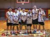 The Quality Games basketball team poses together on the court after a game.