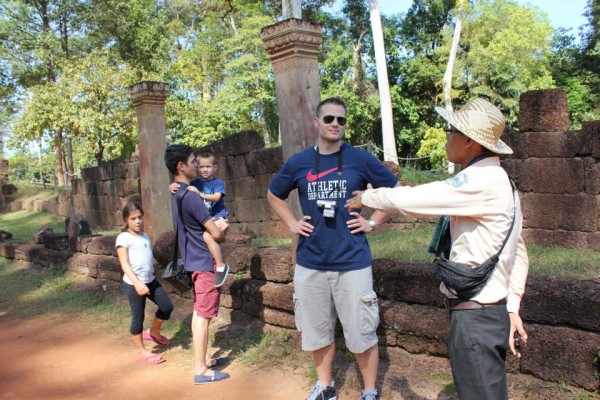 Our fabulous tour guide giving us information about the temples...notice the long sleeve shirt, pants, scarf and hat to protect from the sun and getting darker skin