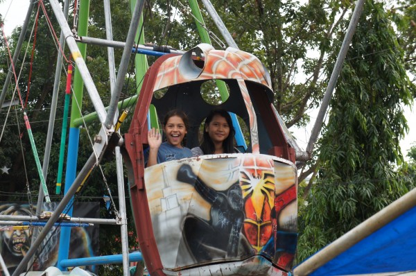 Kalani with her new found cousin Kennybie on a "Ferris Wheel" at the fair