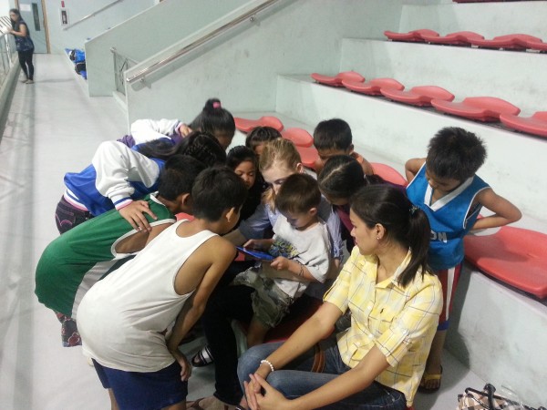 Felicia and Mason with an iPad attracted many kids at a basketball game 