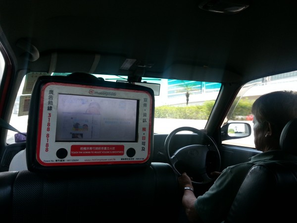 Drivers and cars are on the "opposite" side.  And all of the taxis had some kind of tablet for the passengers to use