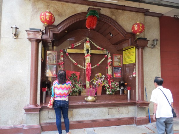 Most Chinese are Buddhist.  Most Filipinos are Catholics.  This place or worship intertwines both religions.