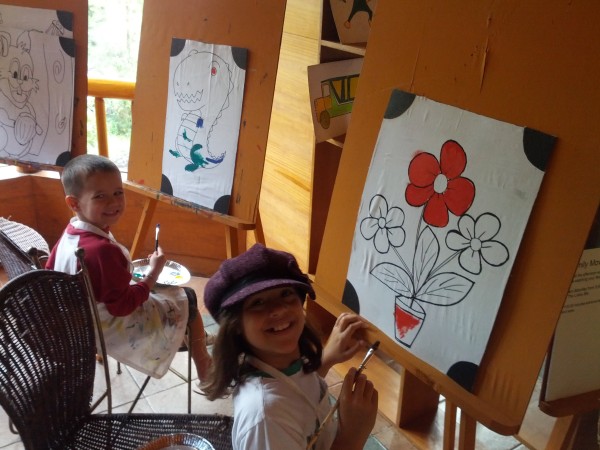 The kids each painted 3 art pieces at the hotel on a rainy day.