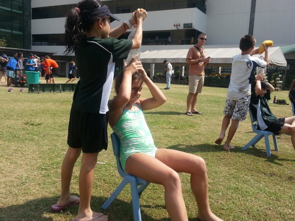 Having fun cooling off with her classmates