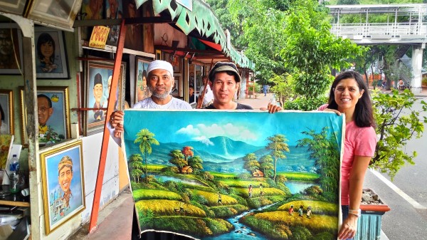 We bought this painting off the street from the artist (middle) on our way to another attraction