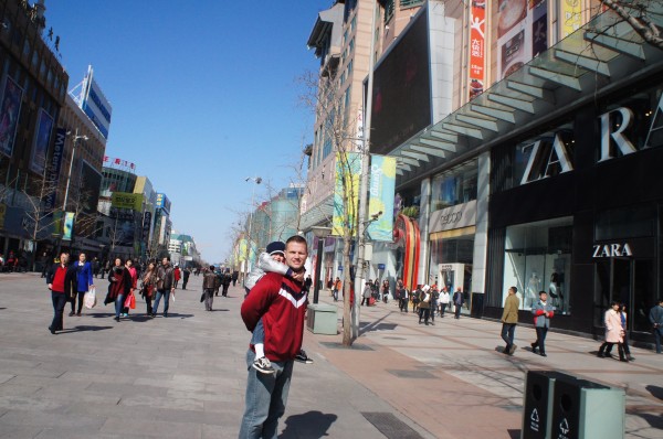 A pedestrian walking street full of stores. Many familiar store were seen