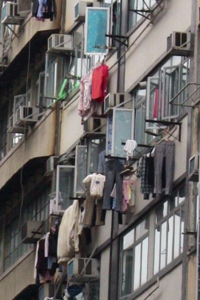 The people in Hong Kong hang dry their clothes right outside their apartment window
