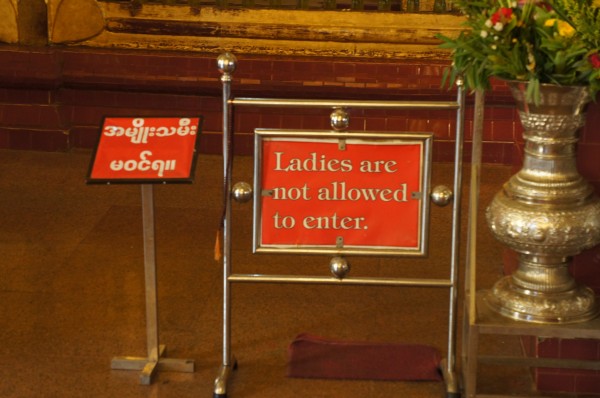 Ladies could only get so close to a Buddha to worship