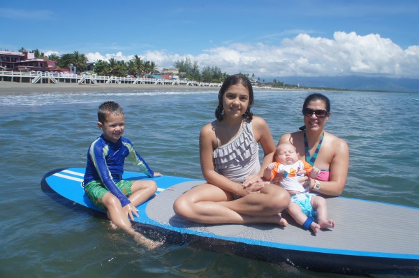 All of the kids on a surf board. This was Blake's first time in the ocean/pool & Kalani's first time back in the ocean after being stung by a jelly-fish