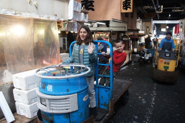 With over 60,000 employee at Tsukiji fish market, not many people get to ride on these trucks that they use to take the fish order from vendor to customer. But, we got lucky and a nice man let the kids jump on for a photo.