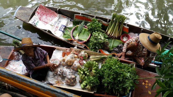 Klong Ladmayom Floating Market is more of a food area where you can buy food inside on solid ground, or outside by boat.