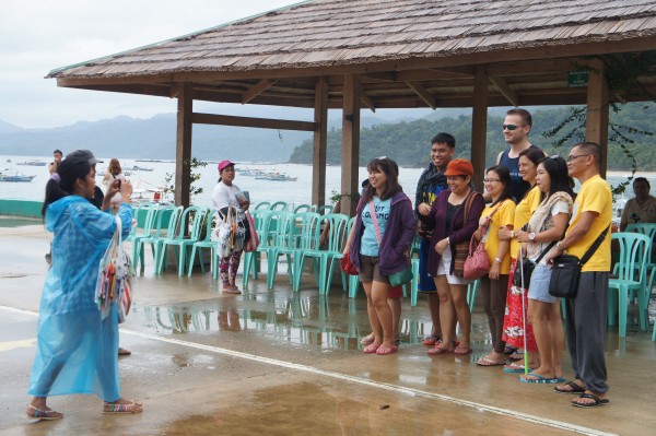 Other people waiting to board the boat for the Underground River asked to take photos with Matt. 