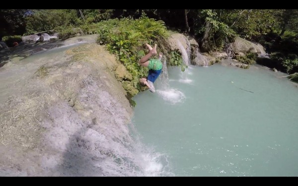 SIx year old Mason doing a flip off a rock at Cambugahay Falls